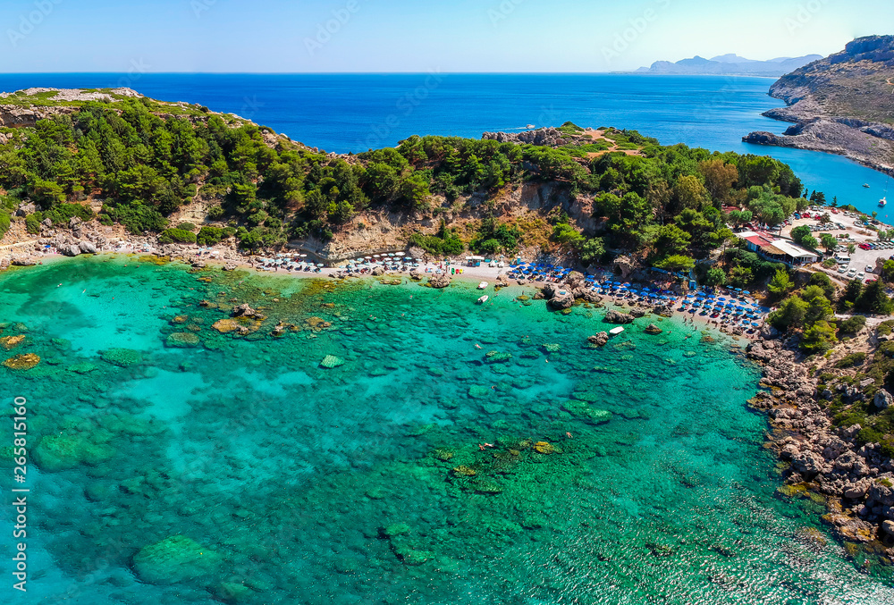 Aerial birds eye view drone photo Anthony Quinn and Ladiko bay on Rhodes island, Dodecanese, Greece. Panorama with nice lagoon and clear blue water. Famous tourist destination in South Europe