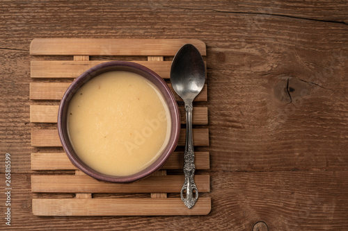 a bowl of soup on wooden table