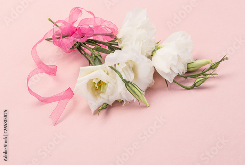 bouquet of white flowers on pink background