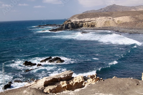 Stunning natural viewpoint with amazing cliffs and blue rough sea at north-west coast of Fuerteventura, Canary Islands, Spain