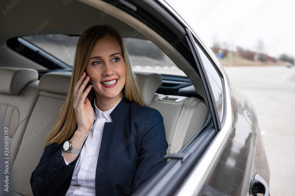 Beautiful businesswoman is driving in the car