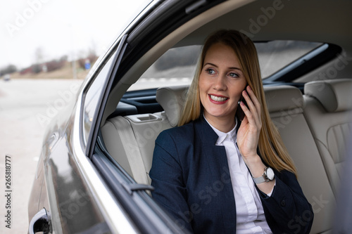 Beautiful young businesswoman is driving in the car