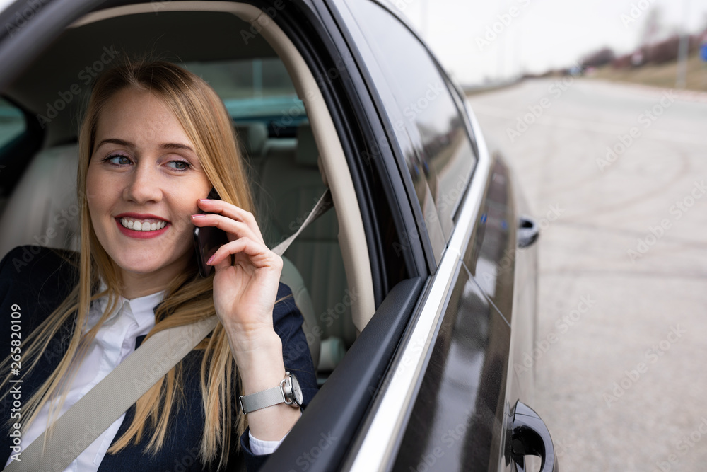 Beautiful businesswoman is driving her car