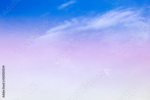A soft fog cloud background with a pastel colored orange to blue gradient © Theeranad