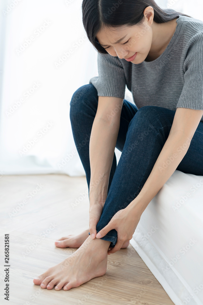 asian unhealthy woman feel hurt hand touch feet or leg with unhappy feeling asian unhealthy woman feel hurt hand touch feet or leg with unhappy feeling