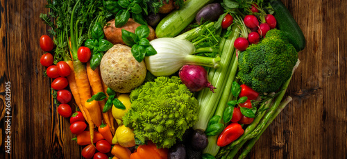 Assortment of fresh vegetables on wooden background