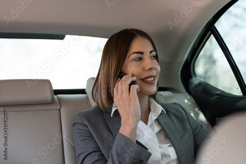 Beautiful young businesswoman is driving in the car