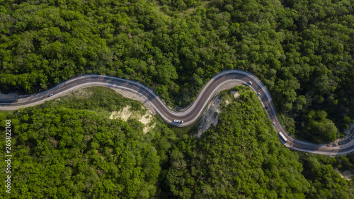 Aerial top view: of cars driving on zig zag winding mountain road