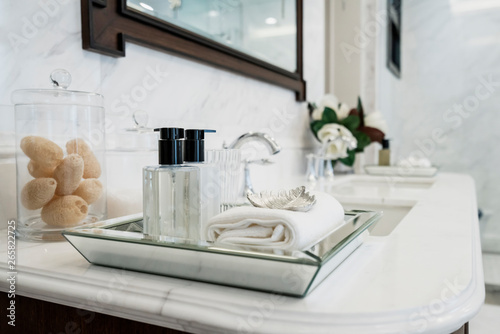 beautiful amenity hotel set on white marble counter in bathroomm photo