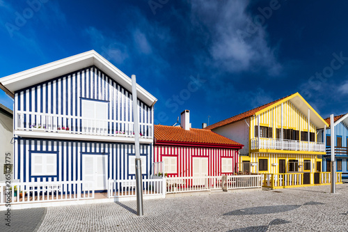 Street with colorful houses in Costa Nova, Aveiro, Portugal. Street with striped houses, Costa Nova, Aveiro, Portugal. Facades of colorful houses in Costa Nova, Aveiro, Portugal.