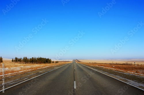Asphalt empty road in a field