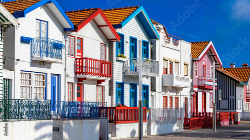 Street with colorful houses in Costa Nova, Aveiro, Portugal. Street with striped houses, Costa Nova, Aveiro, Portugal. Facades of colorful houses in Costa Nova, Aveiro, Portugal.
