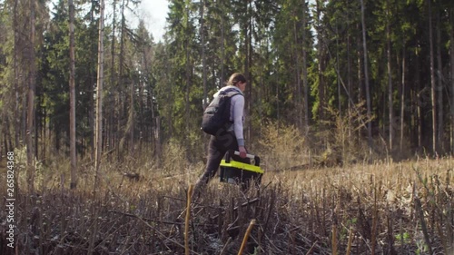 Ecologist on the forest felling marking place on the map. Damage appreciation. Save the planet concept
