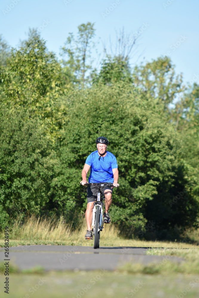 Adult Male Athlete And Exercise Wearing Helmet Riding Bike