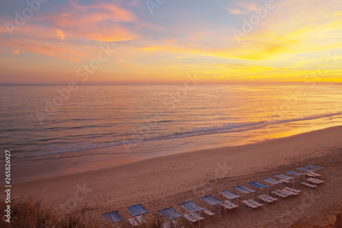 Top view of the picturesque colorful sunset on the sandy seashore. Natural summer background. Beautiful beach landscape