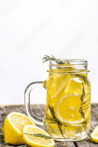 Trendy detox healthy drink. Detox water in bottle with lemon on a wooden table. Summer drink, lemonade. Diet. Copy space