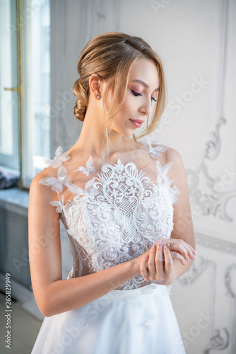 portrait of a beautiful woman in a white wedding dress with a beautiful make-up and hairstyle