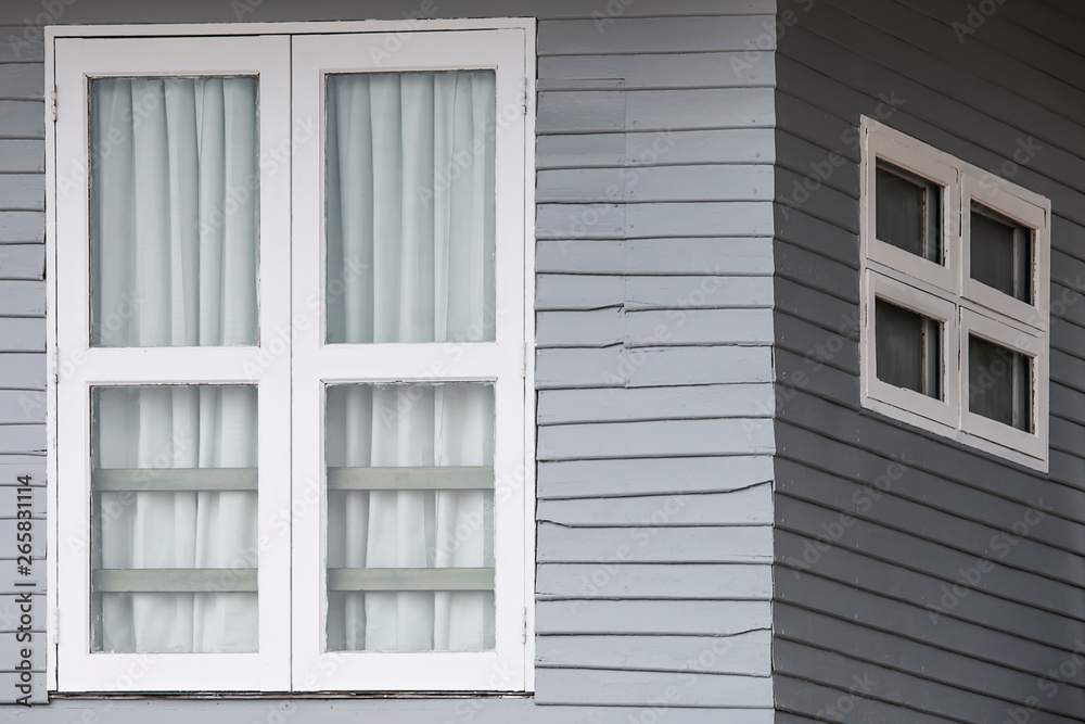 White window doors on old gray wooden houses. White window doors on old gray wooden houses.