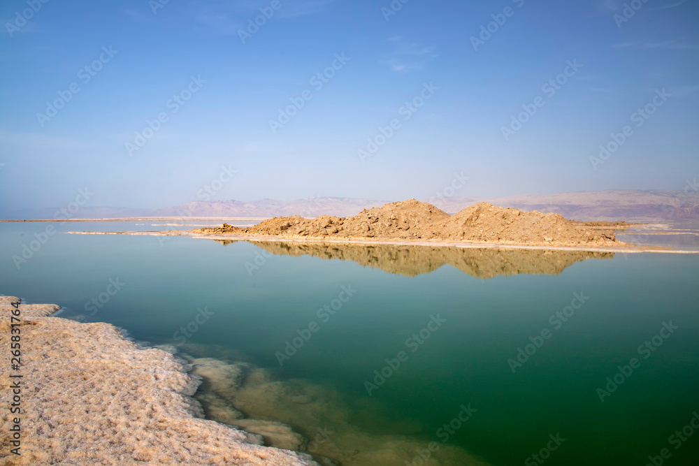 Reflection of hills in the salty water of the Dead Sea