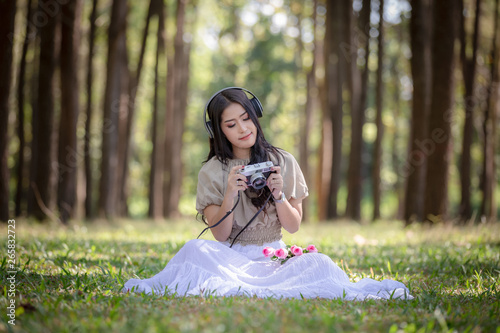 Cuadro en lienzo woman asian girl sitting relax listening to music on headphones Bluetooth and ca