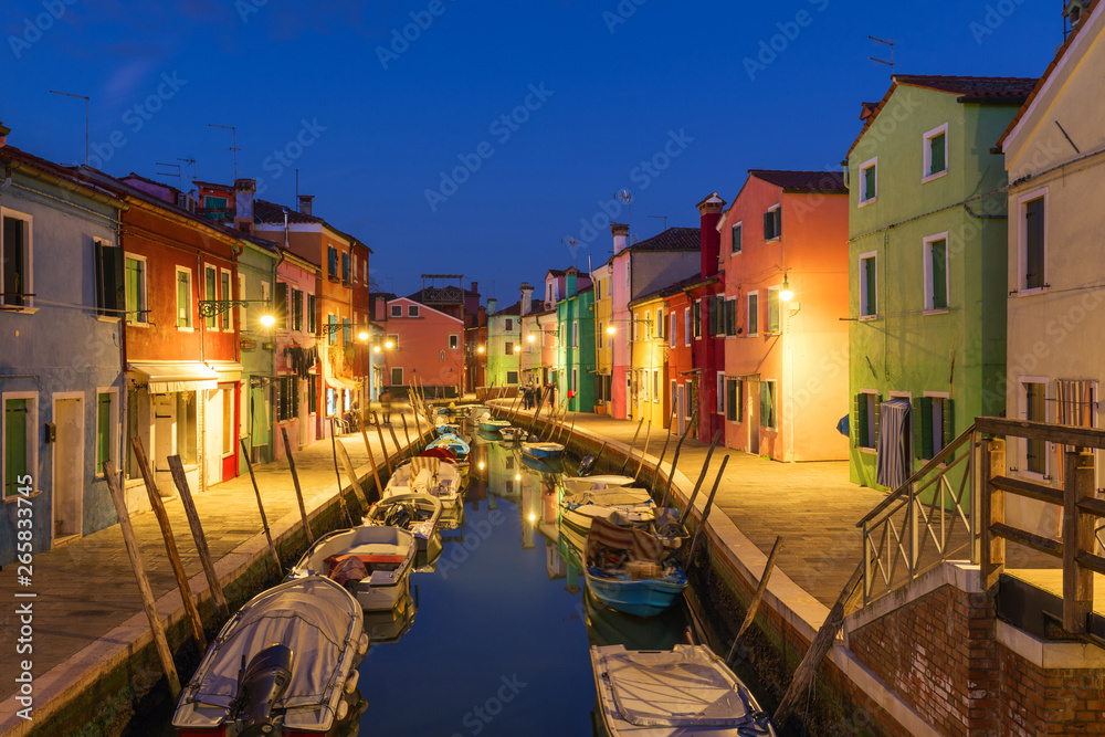 Street view with colorful buildings in Burano island, Venice, Italy. Architecture and landmarks of Burano, Venice postcard. Scenic canal and colorful architecture in Burano island near Venice, Italy