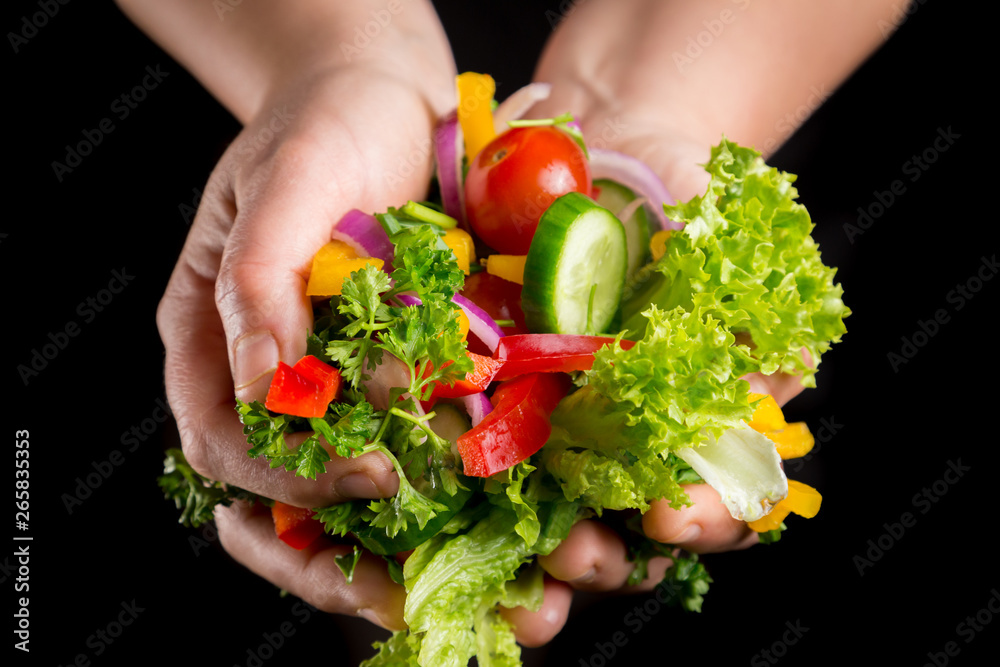 Plenty of wet cut vegetables in woman hands