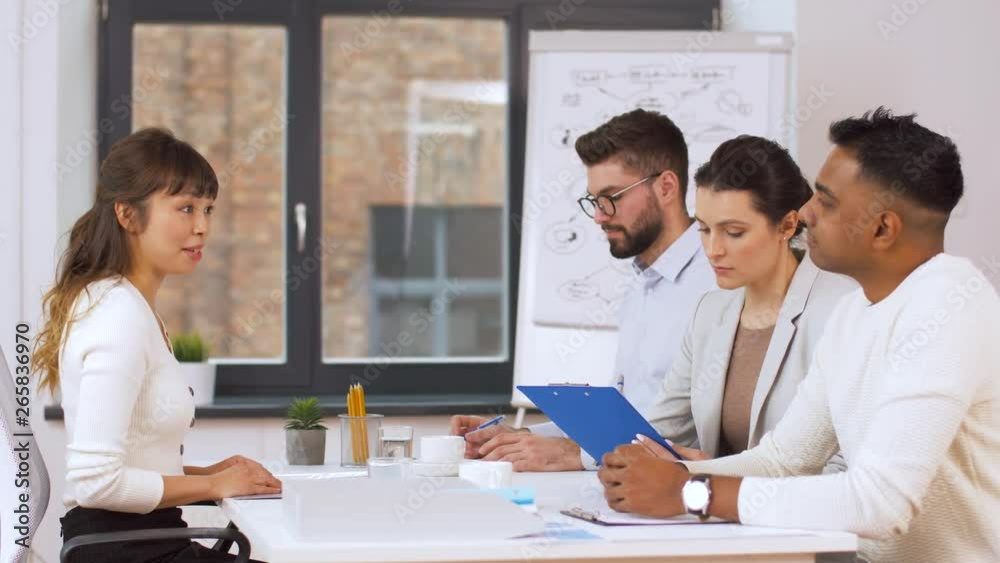 job, hiring and employment concept - international team of recruiters having interview with asian female employee at office job, hiring and employment concept - international team of recruiters having interview with asian female employee at office