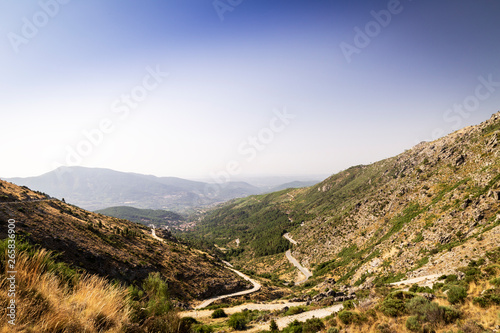Panoramic of some beautiful green mountains with paths and stones