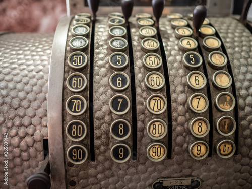 Vintage metal cash register with numbered buttons photo