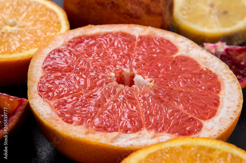 Close up. Sliced in half juicy grapefruit on a black background.