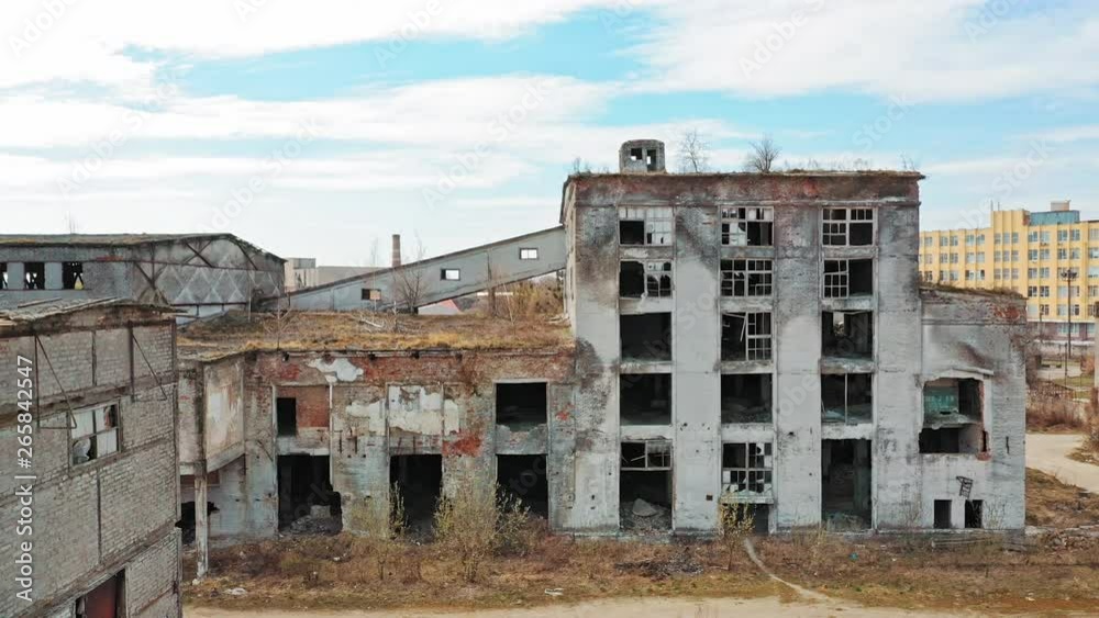 Front facade of abandoned building. Old factory shows the post industrial plight with broken windows Front facade of abandoned building. Old factory shows the post industrial plight with broken windows
