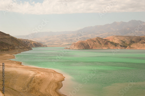 landscape with lake and mountain views. Uzbekistan, Charvak reservoir. Nature of Central Asia