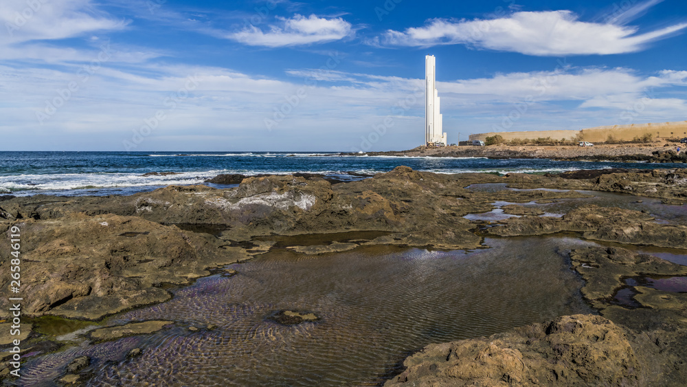 White lighthouse on the rocky coast White lighthouse on the rocky coast