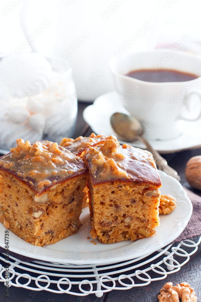 Homemade pie with nuts and raisins of boiled condensed milk cut into squares, selective focus