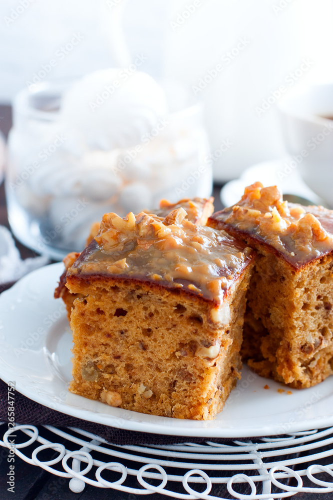 Homemade pie with nuts and raisins of boiled condensed milk cut into squares, selective focus Homemade pie with nuts and raisins of boiled condensed milk cut into squares, selective focus