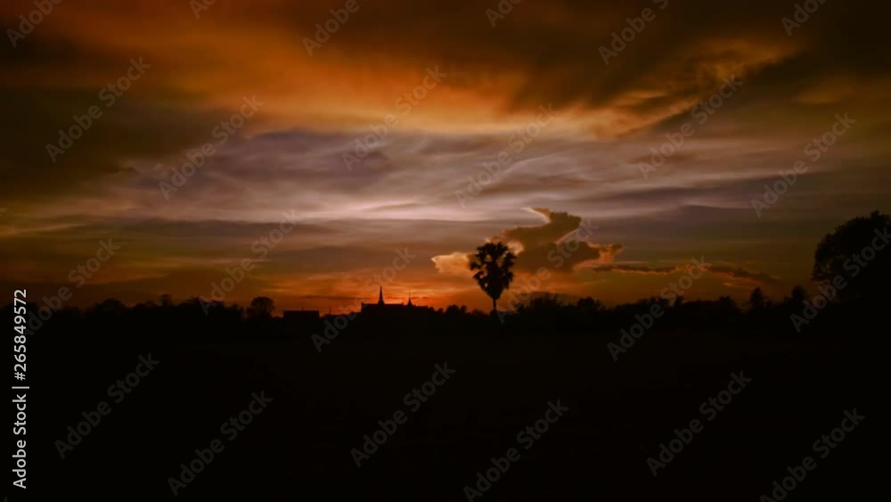 Video Time lapse, sunset atmosphere, in front of a pagoda and a tree in the video scene, the video has a beautiful moving cloud, suitable for the scene, documentaries and advertisements. Video Time lapse, sunset atmosphere, in front of a pagoda and a tree in the video scene, the video has a beautiful moving cloud, suitable for the scene, documentaries and advertisements.