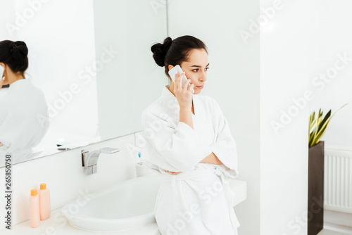 selective focus of attractive young woman  talking on smartphone in bathroom