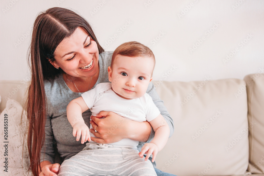 Charming little baby boy 6 months with mother, copy space Charming little baby boy 6 months with mother, copy space