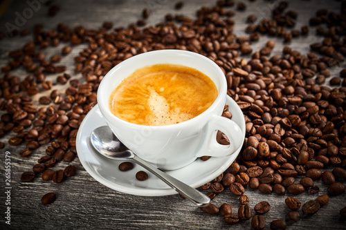 Frothy cup of hot aromatic espresso coffee