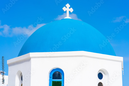 Blue dome of a traditional whitewashed church in Oia, Santorini, Greece photo