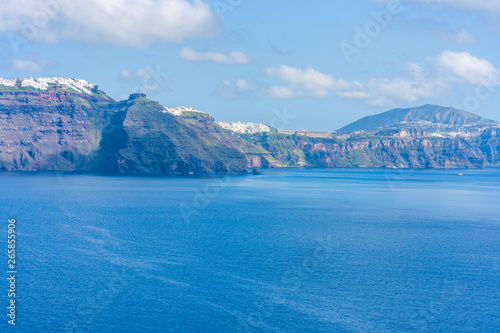Santorini landscape - view of Fira on a cliff across vast caldera filled with water  Greece