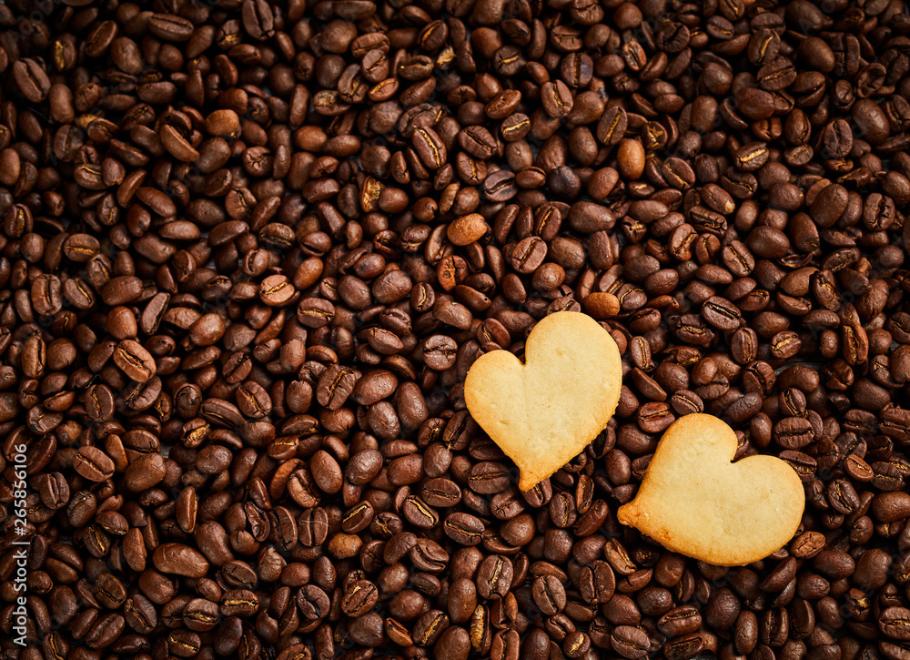 Roasted coffee bean background with fresh pastries Roasted coffee bean background with fresh pastries