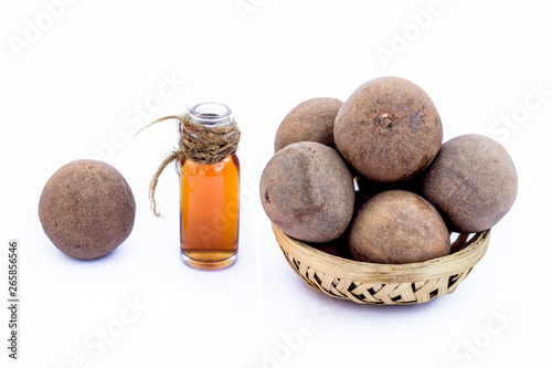 Manilkara zapota, or chikoo isolated on white with its concentration or essence also. photo