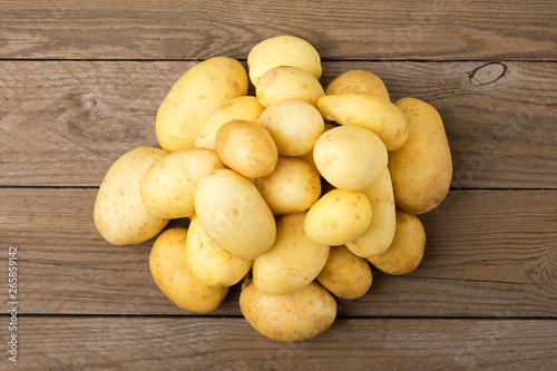 Young potatoes on wooden table. Rustic style. Top view. Flat lay.