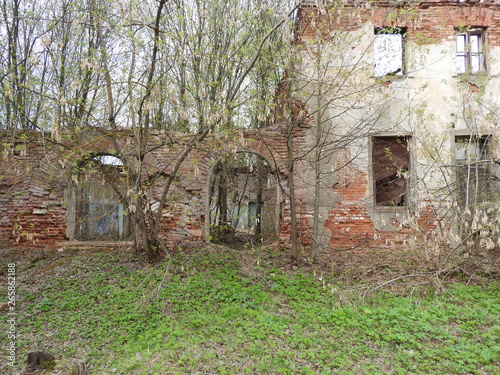 Ruins of an old old red brick and plaster building in the spring in the village of Grebnevo near Moscow, Russia.