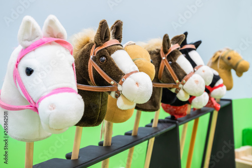 Row of multicolored hobbyhorses - children toys. photo
