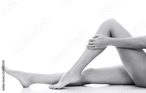 Beautiful smooth and shaved woman's legs. Isolated on white background. Skincare treatment concept