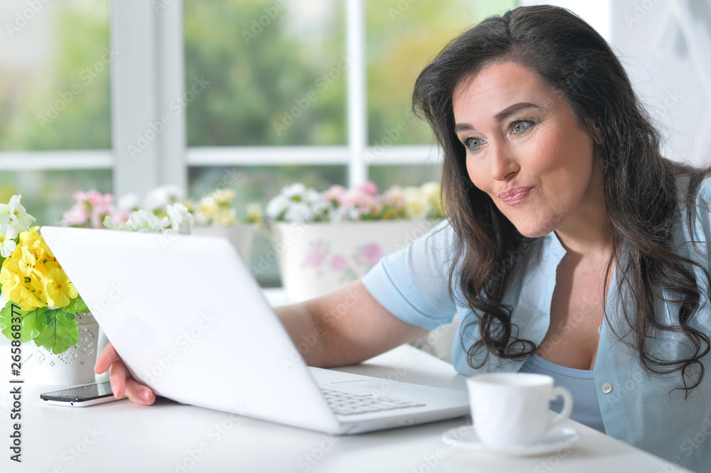 Portrait of a beautiful mature woman using laptop Portrait of a beautiful mature woman using laptop