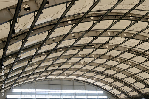 The glass roof of the hangar, industrial building or indoor stadium. Background and texture. Copy space.