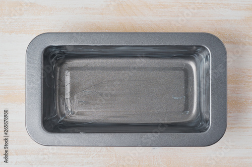 Oil greased baking dish, bread loaf pan with butter. Step by step recipe for Banana bread